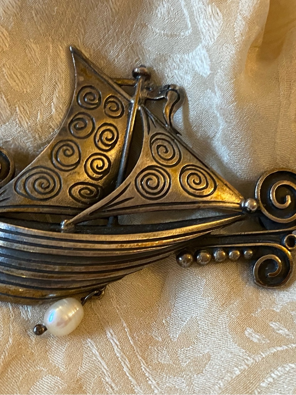 A true vintage boat brooch, marked and signed, with pearl accent.